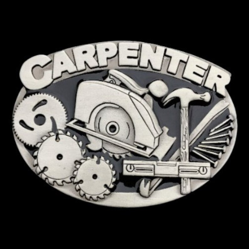 May include: Silver-colored carpenter belt buckle with the word "CARPENTER" in raised letters. The design features a circular saw, gears, a hammer, nails, and a level, all set against a dark gray background.