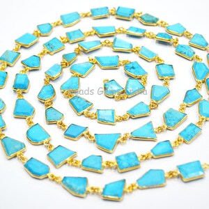 May include: A turquoise gemstone chain necklace with gold links. The turquoise stones are faceted and have a light blue color. The chain is approximately 18 inches long.