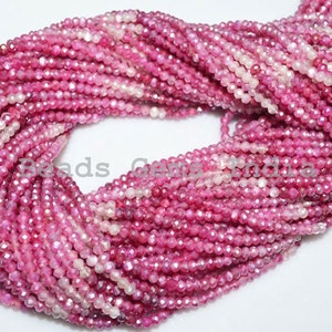 May include: A strand of pink ruby gemstone beads, faceted and strung on a white thread. The beads are small and uniform in size, creating a delicate and elegant look.