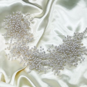 May include: A delicate pearl hairpiece with a cluster of pearl branches, perfect for adding a touch of elegance to any hairstyle.