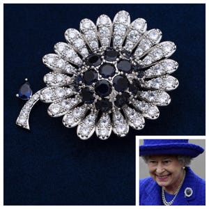The Queens Sapphire Chrysanthemum Brooch Reproduction with 5A Cubic Zirconias and Dark Blue Crystal.