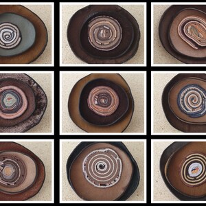 May include: Nine circular leather coasters with concentric circles of different colors and textures. The coasters are arranged in three rows of three.
