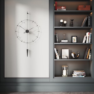 May include: A contemporary wall clock with a black metal frame and pendulum, set against a white wall. Adjacent is a built-in bookshelf, displaying books, candles, and ornaments. The colour palette is neutral, with dark grey accents throughout the room.