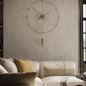 May include: A contemporary wall clock with a black metal frame and a wooden centre. The clock features a pendulum and is suspended on a neutral wall. The clock is above a cream sofa with yellow and green cushions. The clock's diameter is approximately 60 cm.