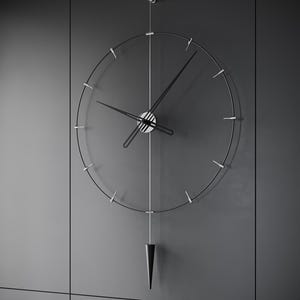 May include: A contemporary wall clock with a minimalist aesthetic. The clock has a transparent face with black hands and hour markers. A black, cone-shaped pendulum hangs beneath. The clock is mounted on a grey wall.