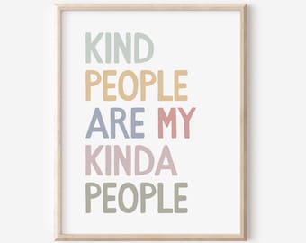 May include: A framed print with the words "KIND PEOPLE ARE MY KINDA PEOPLE" in pastel colors. The text is stacked vertically on a white background, with a light wood-colored frame.