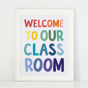 May include: White framed print with the text "WELCOME TO OUR CLASSROOM" in rainbow colors.