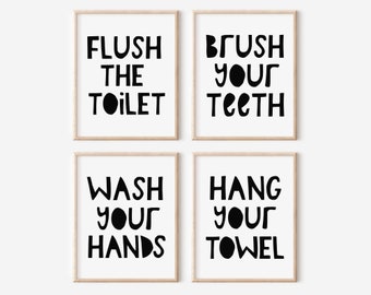May include: Four black and white bathroom signs with a playful font. The signs read "Flush the toilet", "Brush your teeth", "Wash your hands", and "Hang your towel".