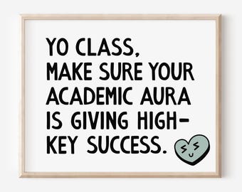 May include: A framed print with the text "YO CLASS, MAKE SURE YOUR ACADEMIC AURA IS GIVING HIGH-KEY SUCCESS." The print has a light wood frame and a small green heart graphic with a smiling face.
