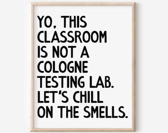 May include: A framed print with the text "YO, THIS CLASSROOM IS NOT A COLOGNE TESTING LAB. LET'S CHILL ON THE SMELLS." The text is in bold black font on a white background, framed by a light wood frame.