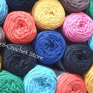 May include: A selection of colourful cotton rope yarn skeins in various shades, including blue, green, yellow, orange, pink, and black. The yarn is arranged in a circular pattern, with the ends of the skeins overlapping. The yarn is ideal for crocheting or macrame projects.