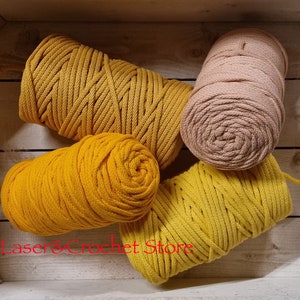 May include: Four spools of cotton rope in a wooden box. Two spools are a bright yellow colour and two spools are a light beige colour.