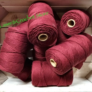May include: A close-up of a pile of maroon coloured cotton rope, ideal for macrame or crafting projects.