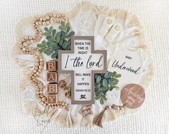 May include: A wooden cross with the text "When the time is right, I the Lord will make it happen, Isaiah 60:22" surrounded by wooden beads, a baby onesie with the text "Baby Underwood", a wooden sign with the text "Arriving April 2025", and a wooden block spelling out "BABY".