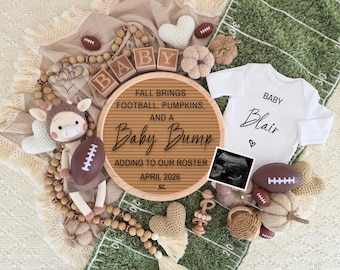 May include: A fall-themed baby announcement with a football, pumpkins, and a baby bump theme. Includes a white onesie with the name "Blair", a sonogram, and a wooden sign that reads "Fall brings football, pumpkins, and a baby bump".