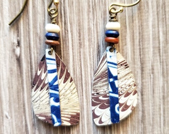 upcycled tin earrings blue and brown geometric and feather pattern hand hammered tin earrings 2 piece with dyed bone beads antiqued brass