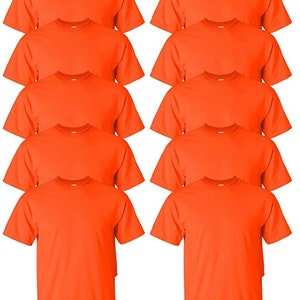 May include: A stack of ten orange crew neck t-shirts. The shirts are made of a soft material and have short sleeves. The shirts are a solid orange color.