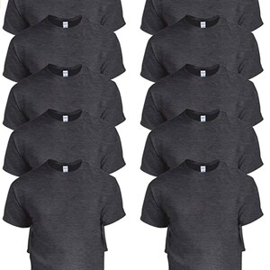 May include: A collection of dark gray crew neck t-shirts. The shirts are neatly stacked, showcasing the short sleeves and the classic neckline. The fabric appears to be a soft, comfortable material, suitable for casual wear. The shirts are displayed in a studio setting.