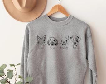 May include: Gray sweatshirt with a black and white illustration of a cat, a dog, and two other dogs. The names Oliver, Luna, Bentley, and Rocky are printed below the illustrations.