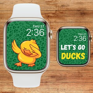 May include: A green and yellow watch face with a cartoon duck wearing a green and yellow leopard print. The watch face displays the time 2:36 and the date THU 27. The watch face also says "Let's Go Ducks".