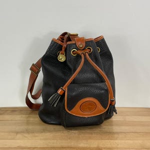 Dooney and Bourke Black and Tan 1 Strap Shoulder Purse / Sling Bag, Dooney and Bourke AWL Pebbled  Bucket Bag with 1 strap and front pocket