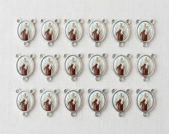 May include: Sixteen silver-toned oval connectors with a religious image of a figure holding a child. The image is framed in an oval and set against a light blue background. The connectors have three loops for attaching to other components.