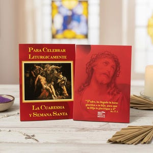 May include: Two red religious cards with Spanish text. One features a painting of a biblical scene, the other a portrait of Jesus. A lit candle, a small bowl of purple sand, and a rosary are also visible.