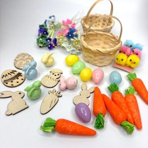May include: A collection of Easter-themed decorations, including pastel-colored eggs, bunnies, chicks, carrots, and a basket. There are also wooden cutouts of eggs and bunnies.