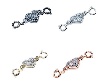 May include: Four heart-shaped jewelry clasps with crystal accents. The clasps are in silver, gold, and black.