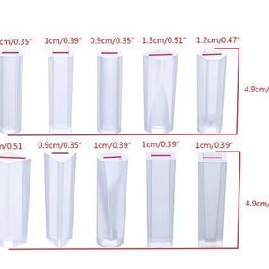 May include: Set of 10 clear plastic molds for making candles or soap. The molds are rectangular and come in various sizes, ranging from 0.9 inches to 1.3 inches in width and 4.9 inches in height.
