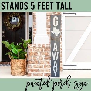 May include: A gray wooden porch sign with white lettering that reads "G AWAY" with a white outline of the state of Texas in the middle. The sign stands 5 feet tall.
