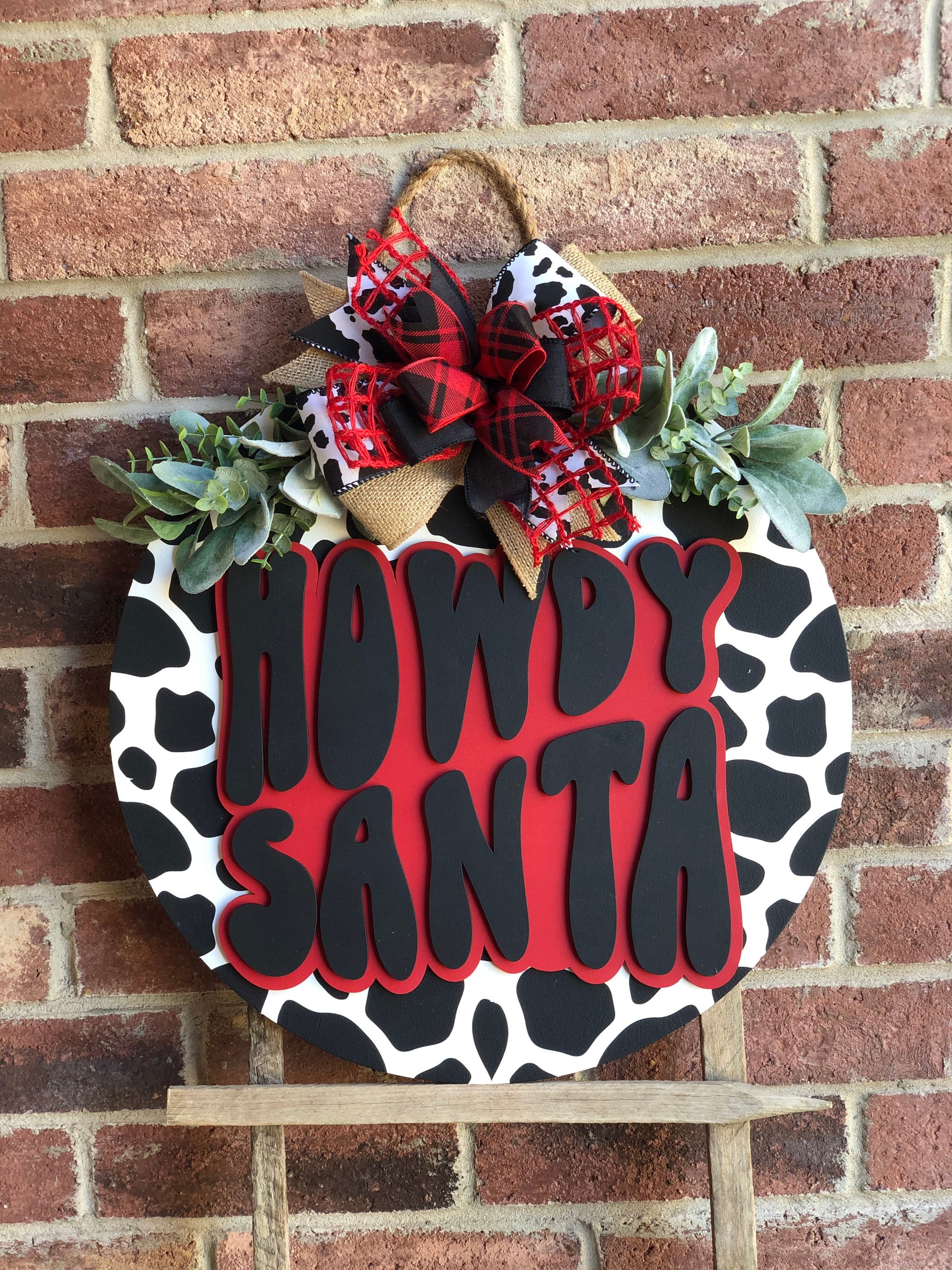 37 Inviting Christmas Front Porch Decor Ideas to Welcome Guests: Festive Ways to Wow Your Neighbors 10 Retro Howdy Santa Door Hanger, Cow Print Merry Christmas Front Door…