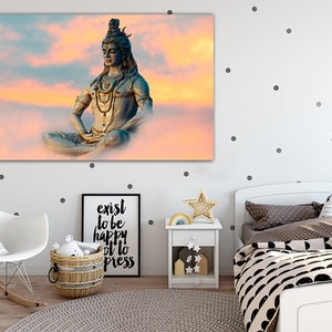 May include: A blue statue of Shiva meditating in a lotus position against a pink and orange cloudy sky.