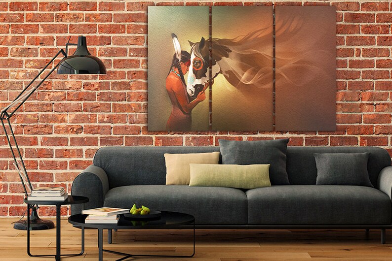May include: A three-panel canvas print depicting a Native American woman with a headdress, embracing a white and brown horse. The background is a soft, golden brown with a hazy effect.