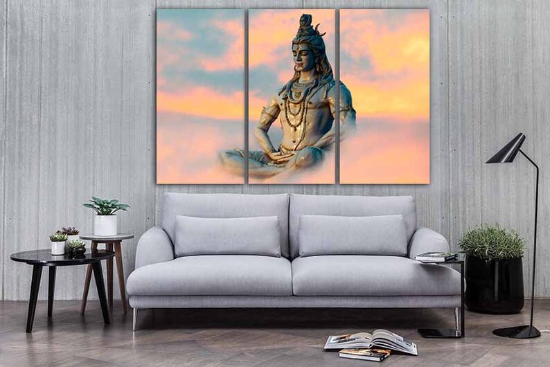 May include: A three-panel canvas print featuring a meditating figure of Shiva, a Hindu deity, against a backdrop of a colorful sunset sky.