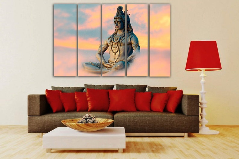 May include: A multi-panel canvas print featuring a meditating Hindu deity, Shiva, in a serene pose against a backdrop of clouds and a sunset sky.