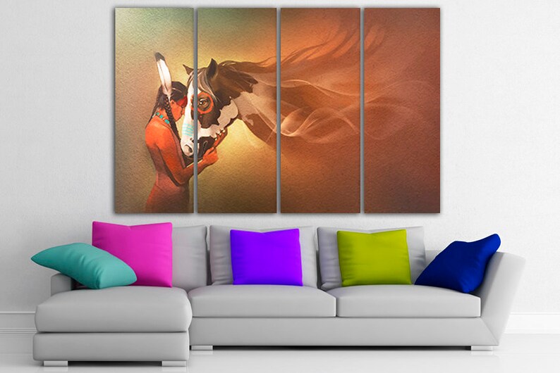 May include: A multi-panel canvas print featuring a Native American woman with a headdress, looking at a brown and white horse with flowing mane. The background is a soft orange and yellow gradient.