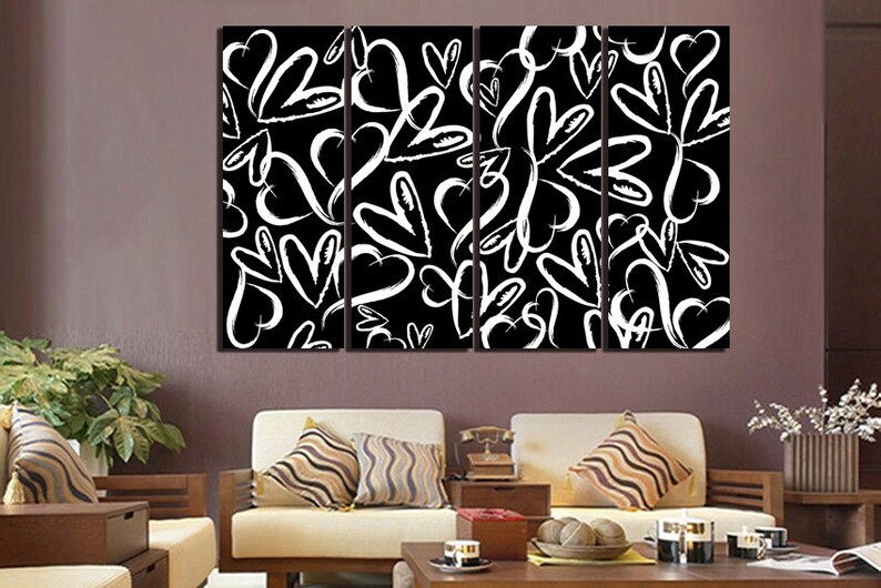 Puede incluir: Una impresi&oacute;n de arte de pared de lienzo en blanco y negro con un patr&oacute;n repetitivo de corazones blancos sobre un fondo negro. La impresi&oacute;n est&aacute; dividida en cuatro paneles.