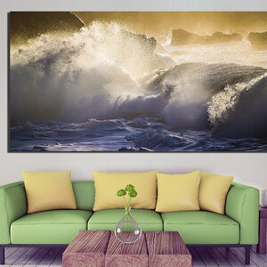 May include: A large canvas print featuring a dramatic seascape with crashing waves and a golden sky.