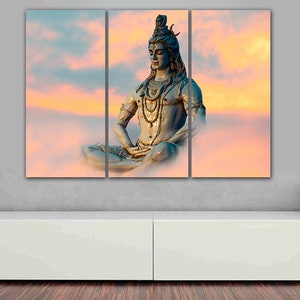 May include: A three-panel canvas print featuring a blue statue of Shiva meditating in a lotus position against a backdrop of pink and orange clouds.