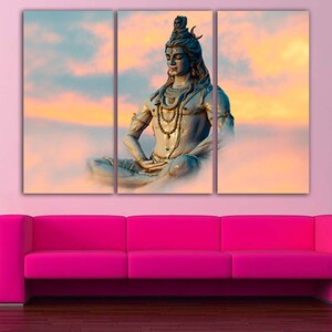 May include: A three-panel canvas print featuring a blue statue of Shiva meditating in a lotus position against a backdrop of a colorful sunset sky.