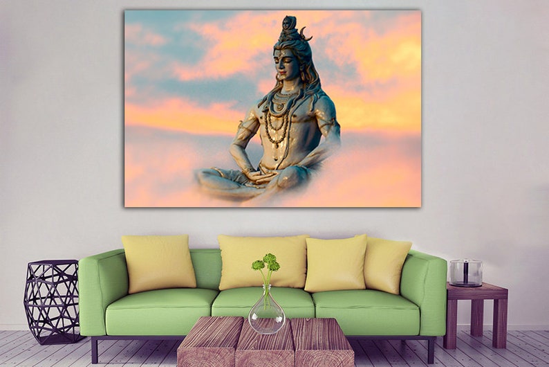 May include: A blue statue of Shiva, a Hindu deity, meditating in a lotus position against a background of pink and orange clouds.