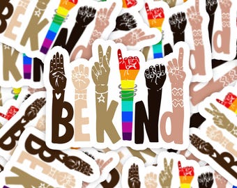 May include: A sticker featuring the text BE KIND, where each letter is formed by a hand making a sign language gesture. The hands vary in skin tone and include patterns like stars, hearts, and a rainbow gradient on the letter I.