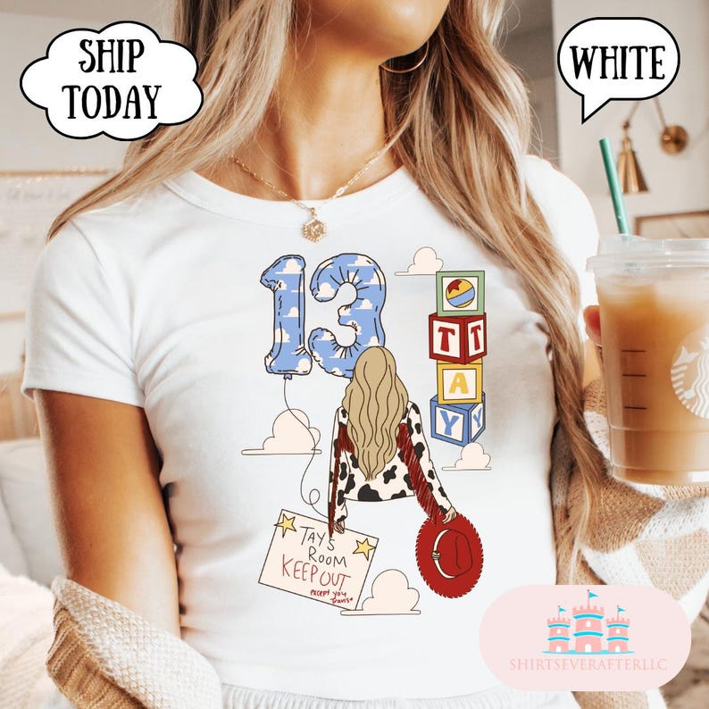 May include: A white t-shirt featuring a graphic print of the number 13 in a blue sky pattern, a person with long blonde hair wearing a cow print jacket, a red hat, a sign reading TAYS ROOM KEEP OUT, and a stack of colorful alphabet blocks.
