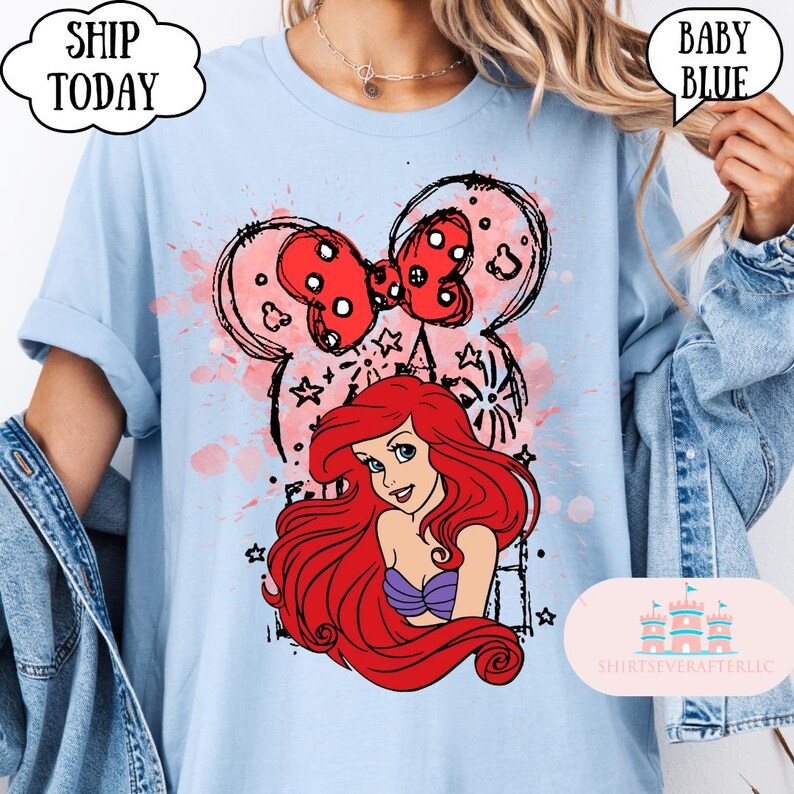 May include: Baby blue t-shirt featuring a graphic of Ariel from The Little Mermaid, with a red bow and Mickey Mouse ears design. The shirt has the text "Ship Today" and "Baby Blue". The shirt is from ShirtsEverAfterLLC.
