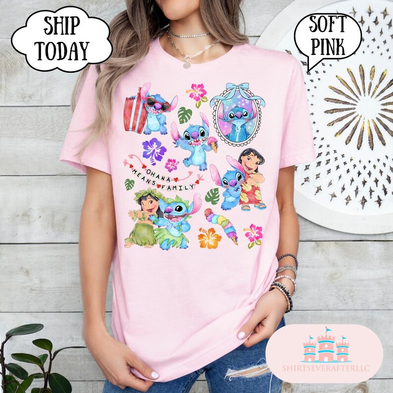 May include: Pink t-shirt with a colorful graphic print of Stitch characters from the Disney movie Lilo & Stitch. The shirt features the text "Ohana means family" and several Stitch characters in various poses.