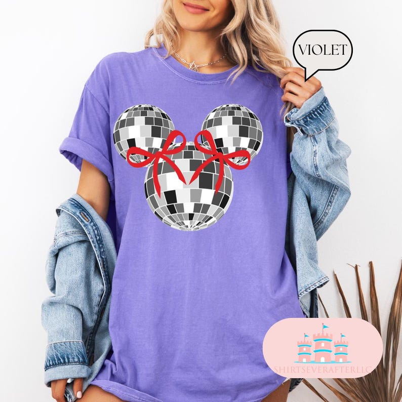 May include: Purple t-shirt featuring a black and white disco ball Mickey Mouse design. The disco balls have red bows on them. The text "VIOLET" is in a white speech bubble.