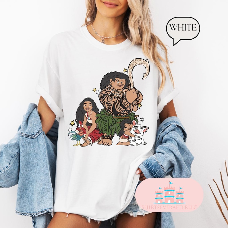 May include: White t-shirt with a graphic print of Maui, Moana, and Pua from the Disney movie Moana. The characters are depicted in a cartoon style with vibrant colors.