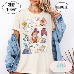 May include: Cream-colored t-shirt featuring colorful cartoon illustrations of characters from a popular animated movie. The shirt includes the text "I can go the distance" and the word "NATURAL" in a speech bubble.