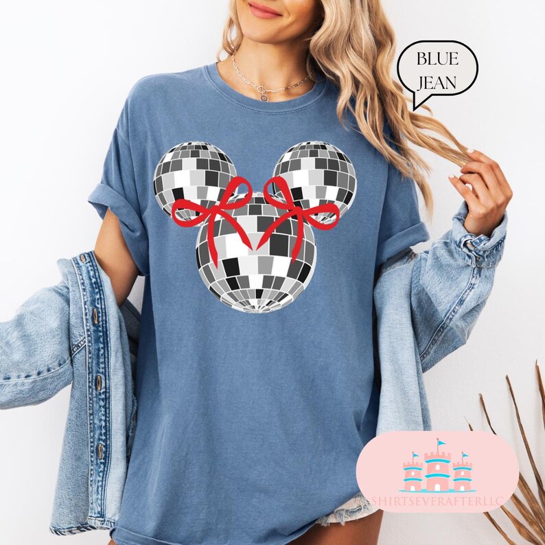 May include: A blue jean t-shirt featuring a black and white disco ball Mickey Mouse design. The disco balls have red bows on them.